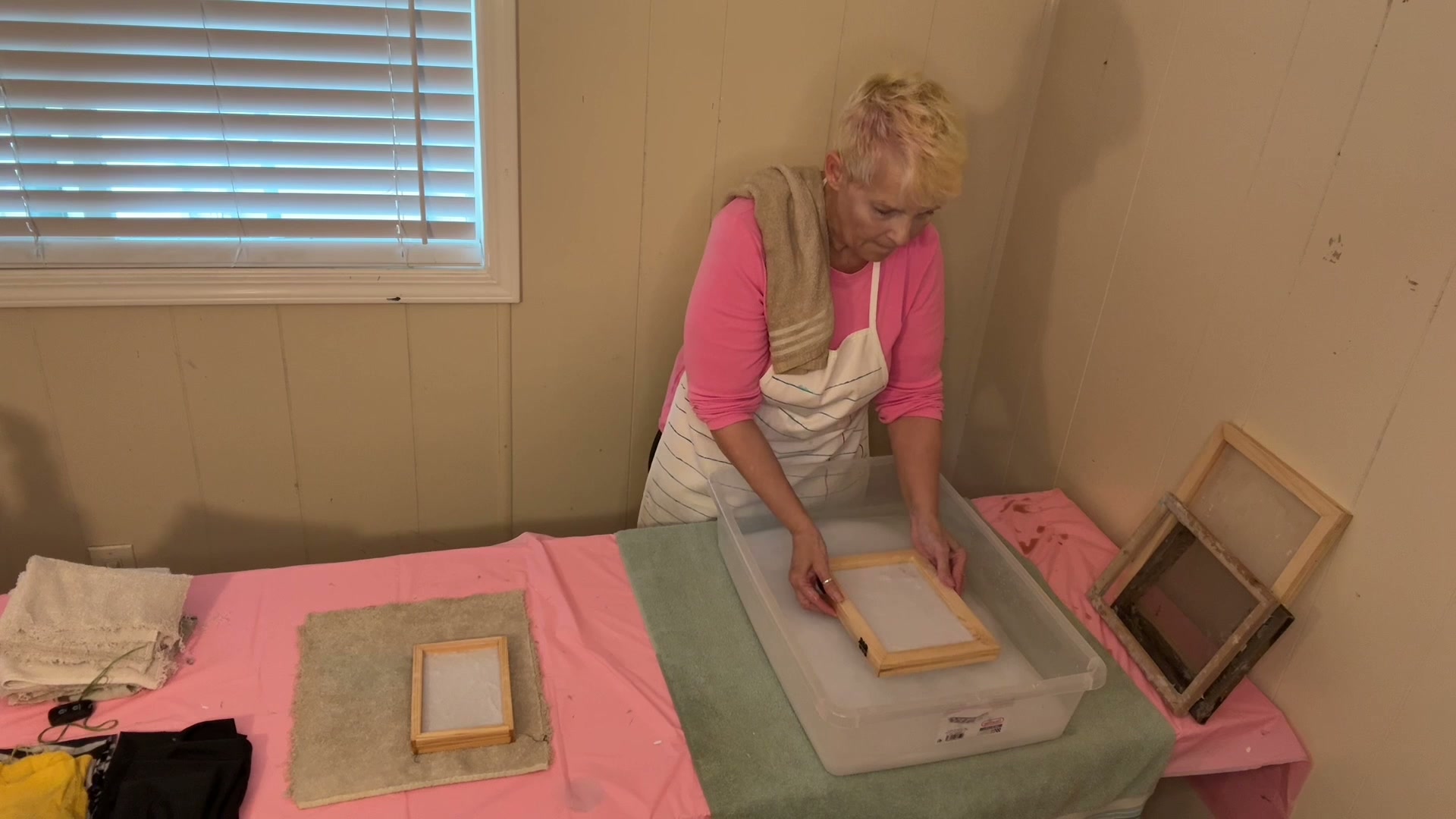 Angela dipping the mould into pulp
